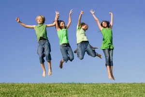 group of happy smiling summer children jumping